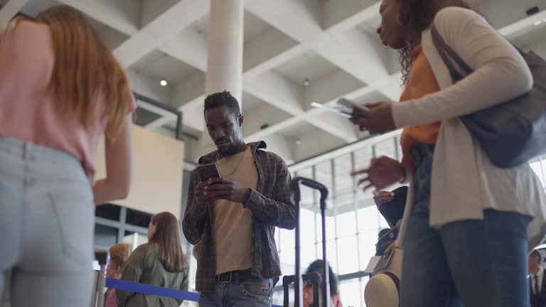 Young Traveler Waiting in Line at the Airport Check-In