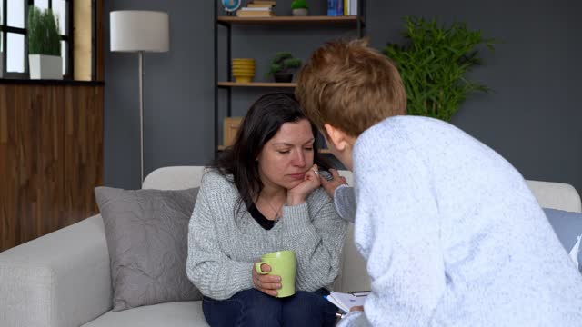 A woman is receiving help by a psychologist