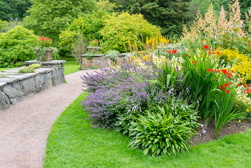 Flowerbeds, Grass Pathway and Ornamental Vase in a Formal Garden
