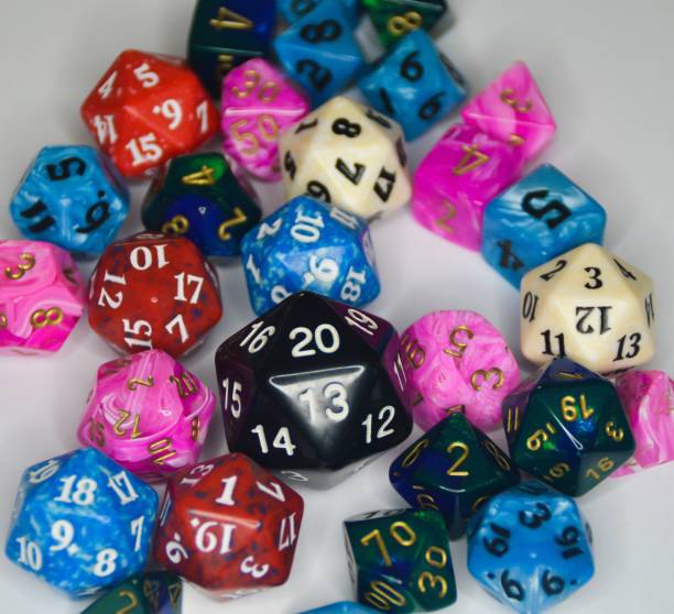 istock Group of multicolored dice sets with numbers on a white table 1486025037