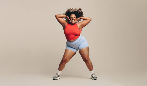istock Fun and body movement: Fit woman enjoying a dance workout in a studio 1486027349