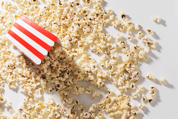 istock Classic striped bucket with delicious popcorn on white background 1486029366