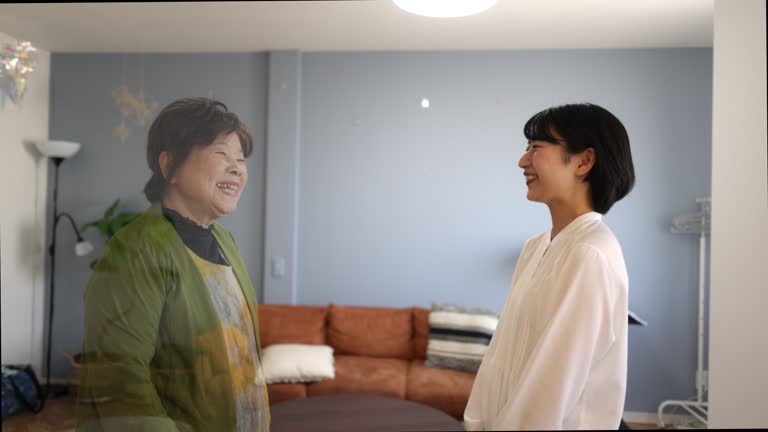 Young woman talking to her grand mother in virtual screen