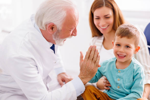 istock Little boy doing high five with dentist after checkup 1486030082