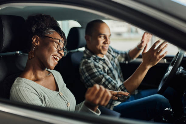 istock Cheerful black couple having fun on a trip in a car. 1486031838