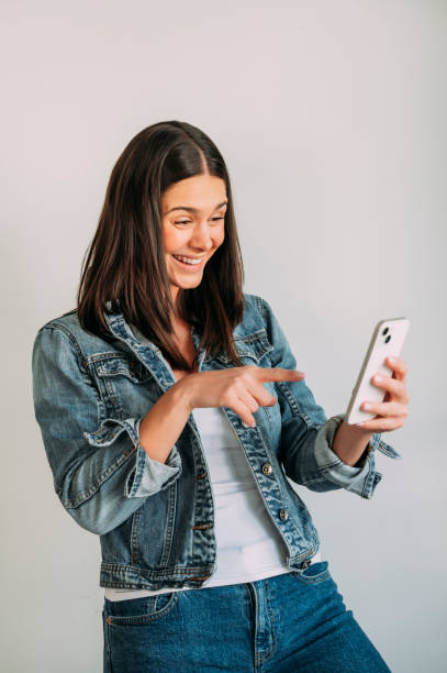 istock Euphoric woman looking at her smartphone 1486031895