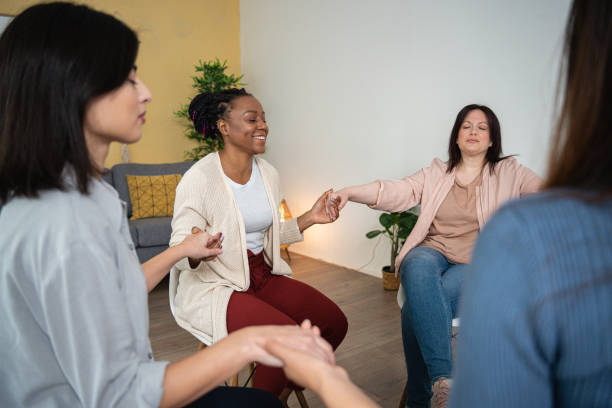 istock Multiracial group of women, having group therapy, while holding hands 1486031938