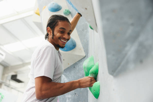 istock Close Up Of Smiling Man Enjoying Climbing Wall In Indoor Activity Centre 1486032144