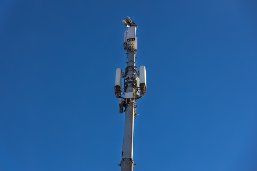 Close up of antenna repeater tower on blue sky. High quality photo