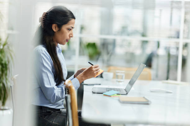 istock Indian female entrepreneur working on laptop in the office. 1486034497