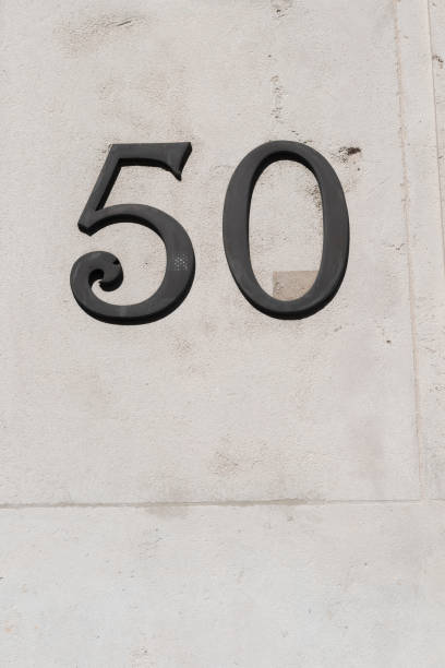 istock Number fifty one in dark figures on white stone wall 1486038664