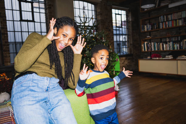 Brother and sister gesturing, laughing, having fun
