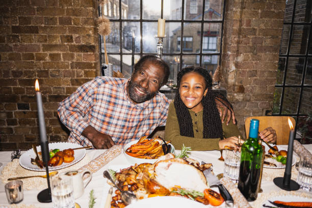 candid portrait of man and granddaughter at christmas lunch - white meat flash imagens e fotografias de stock