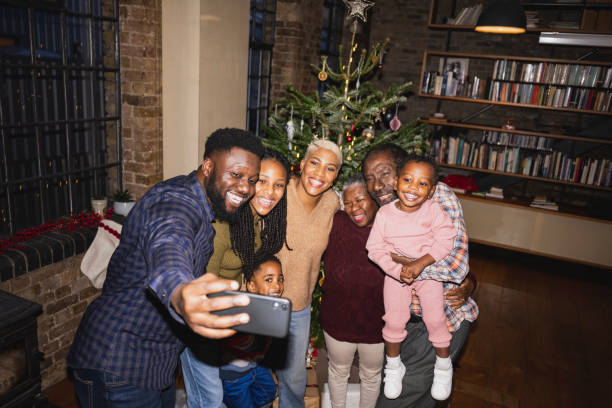 three-generation black family taking christmas selfie - pre teen boy flash imagens e fotografias de stock