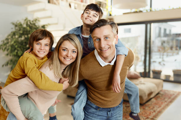 istock Happy family having fun while piggybacking at home. 1486040548