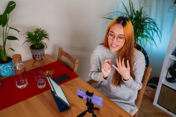 istock Woman vlogging with mobile phone 1486041518