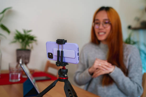 istock Woman vlogging with mobile phone 1486041588