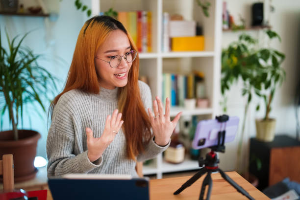 istock Woman vlogging with mobile phone 1486041885
