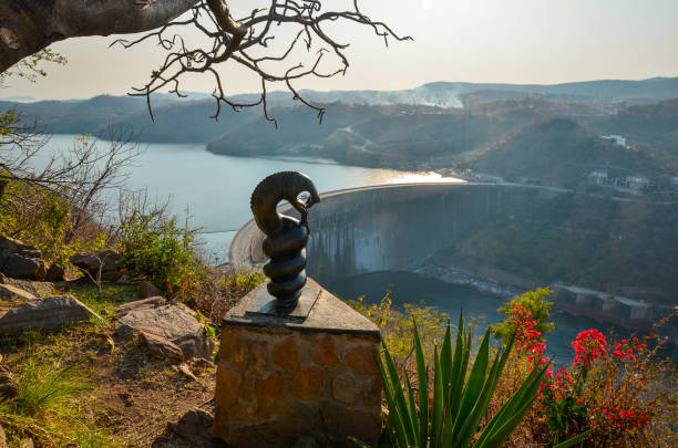 A stone carving of Nyaminyami overlooks Kariba Dam wall, Zimbabwe, Africa stock photo