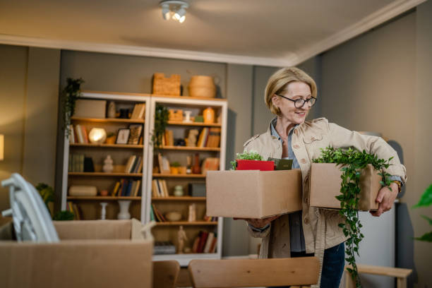 istock Mature woman unpacking boxes 1486050228