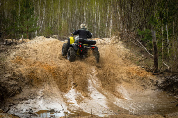 istock ATV/UTV/4x4 rider throw splashing past a muddy puddle 1486052646