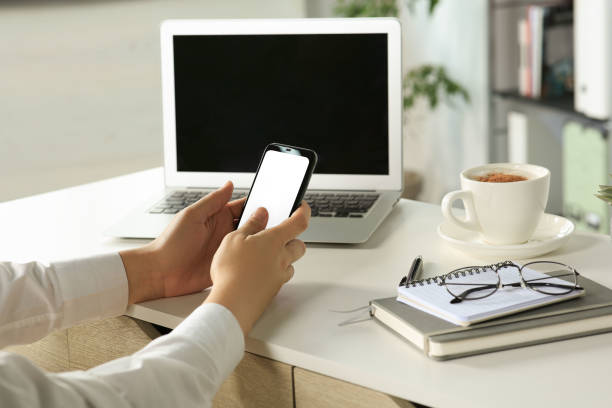 istock Woman using smartphone at table indoors, closeup 1486052877