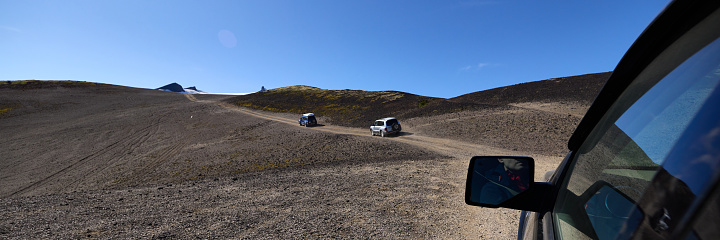 Two Mitsubishi Pajero off-road vehicles climbing the Snæfellsjökull stratovolcano. The view from the third car behind them. Snaefellsnes Peninsula, Iceland, August 14, 2021