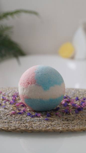istock Beautiful bath bomb on wicker mat indoors 1486053507