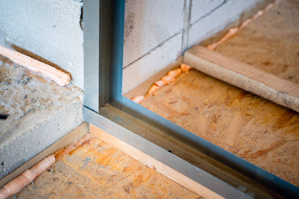 istock Corner connection of a metal profile when building a frame for drywall. Adjusting the height to the length of the profile with wooden beams. Aerated concrete walls and rough floor from OSB slabs 1486053654