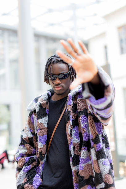 istock Young man with sunglasses gesturing with his hand 1486053726