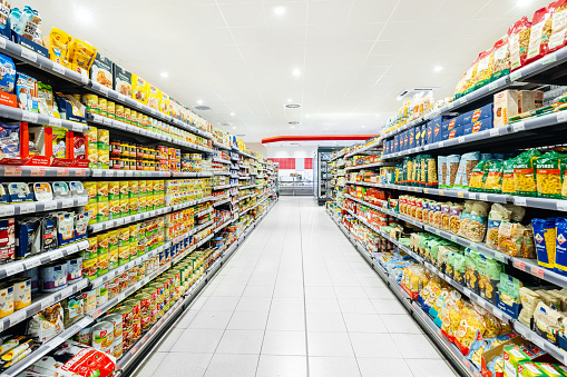 A supermarket aisle filled with a variety of food items neatly stacked and arranged.