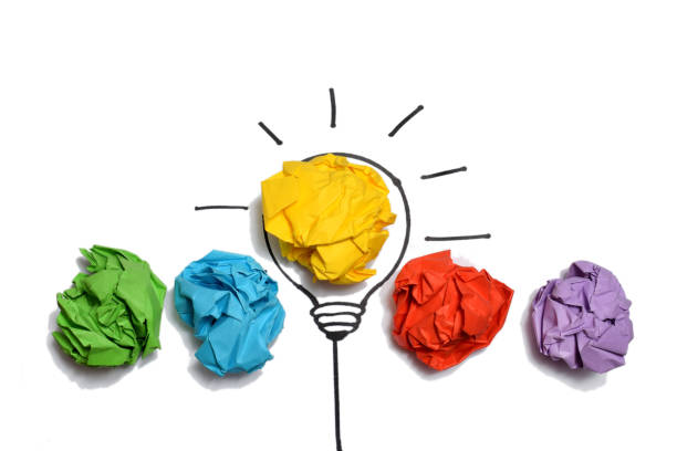 istock Creative thinking ideas and innovation concept. Paper scrap ball yellow colour with light bulb symbol 1486058361
