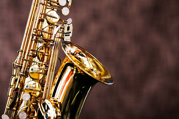 istock Shiny bright saxophone in close up against brown background 148605875
