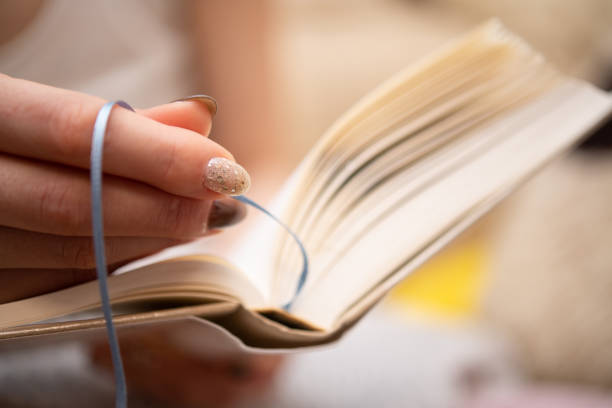 Close-up image of witch reading spell in old book to exorcise the evil spirit