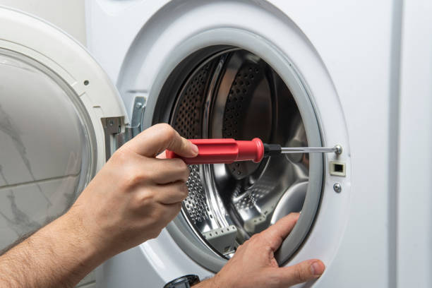 istock plumber fixing washing machine in bathroom, closeup 1486063164