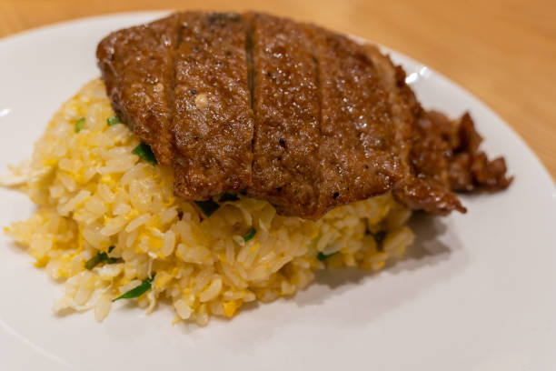 Close-up view of the pork chop egg fried rice on the plate. stock photo