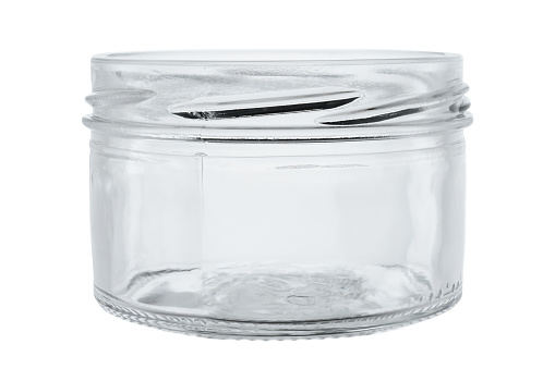 Transparent glass jar, for foodstuffs. On a white background, close-up.