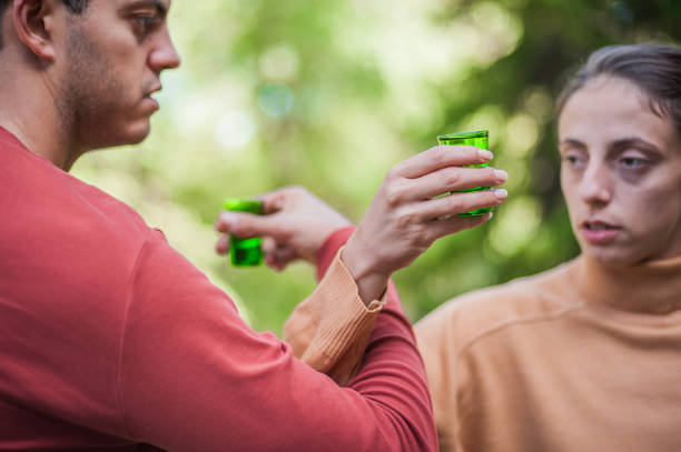 istock Cheers. Very drunk couple chug shot drink from small glasses 1486070462