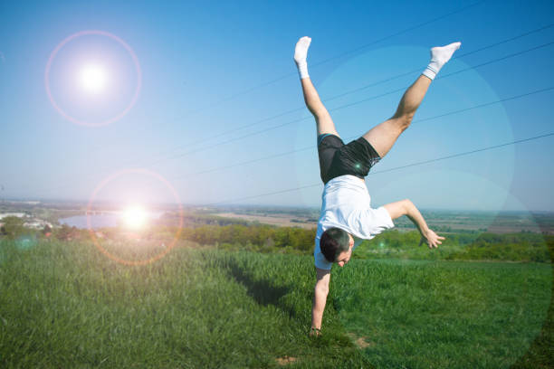 istock young guy standing on one hand, training in nature with a beautiful view, physical and mental strength, healthy life 1486072277