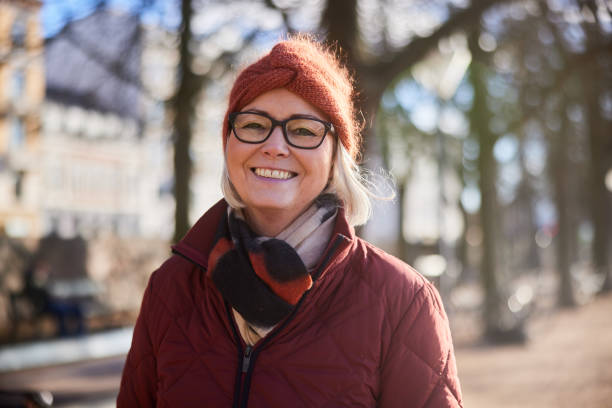 Senior woman smiling while walking outside on a sunny winter day
