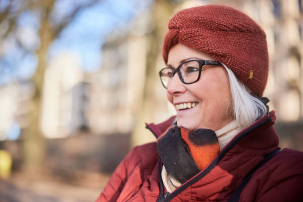 istock Senior woman smiling while out for a walk in winter 1486072951