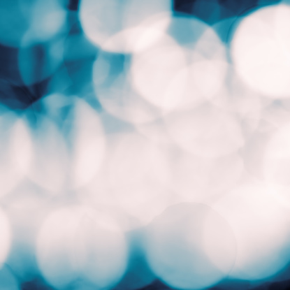 A photographed background of defocused lights, in monochrome dark blue and white.