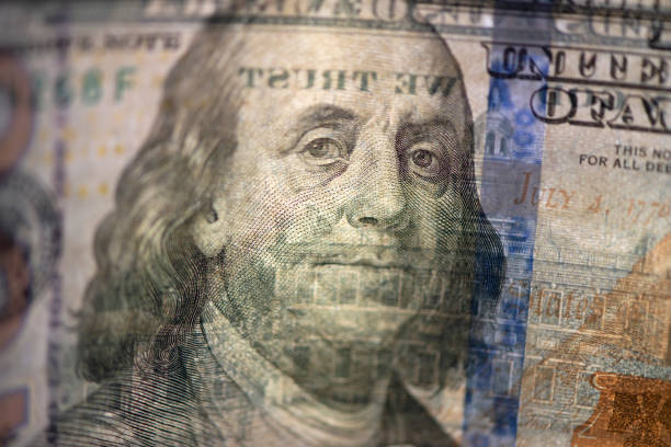 istock Hundred of US dollars on black background 1486073104