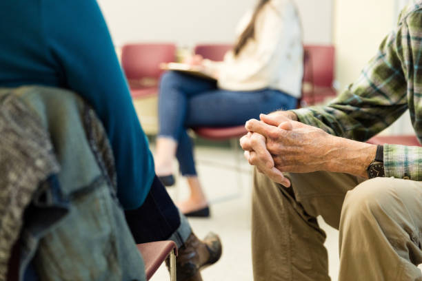 istock Unrecognizable senior man clasps hands in group therapy 1486074203