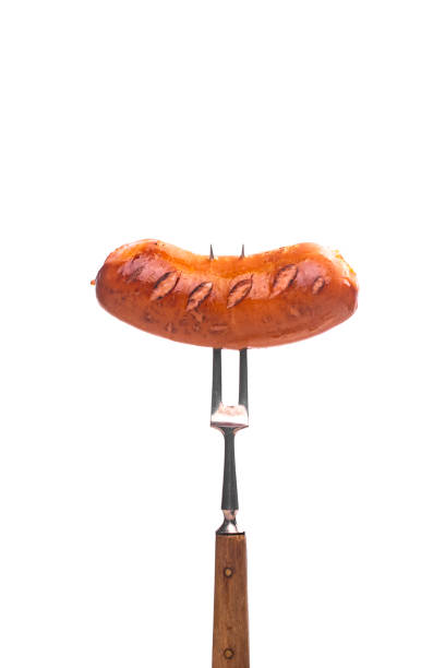istock Grilled sausage on a fork isolated on white background. 1486074391