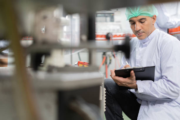 istock quality supervisor or food or beverages technician inspection about condition control food or beverages before send product to the customer. Production leader recheck machine and productivit 1486074796