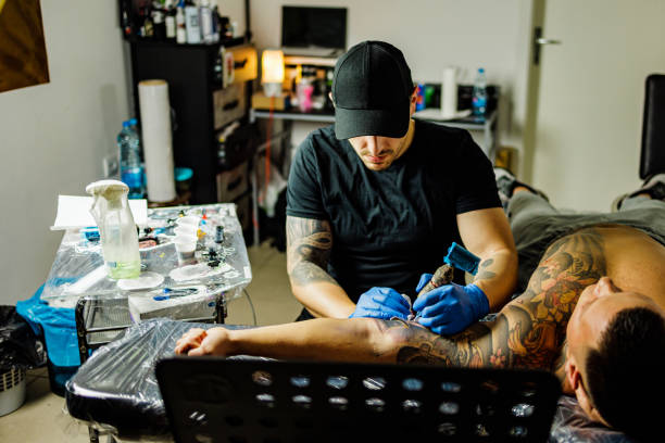 istock Artist tattooing a man in studio 1486075878