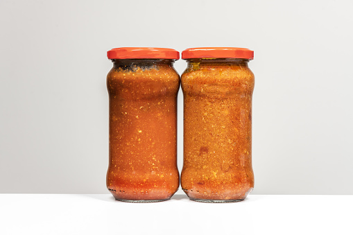 Two glass jars of canned red tomato sauce for pasta in jpg format