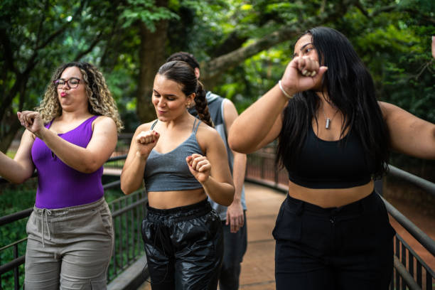 istock Friends walking and dancing at the park 1486078467