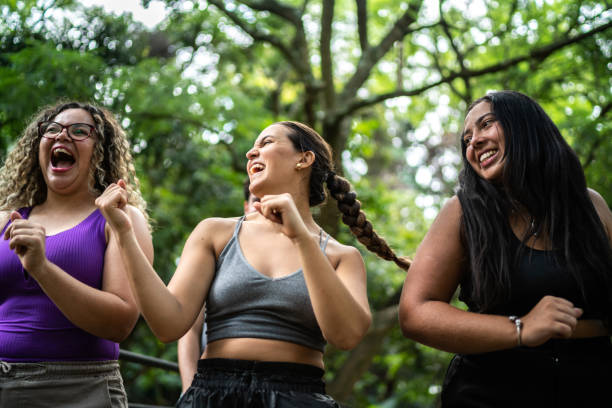 istock Friends walking and dancing at the park 1486078474